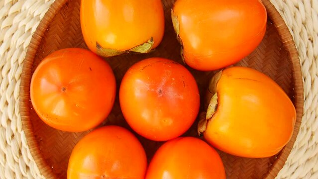 Ripe persimmon in the basket.