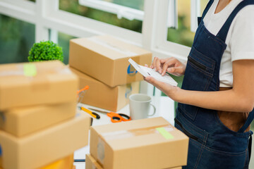 Asian woman, entrepreneur, small business, SME, independent, press the calculator to account for...