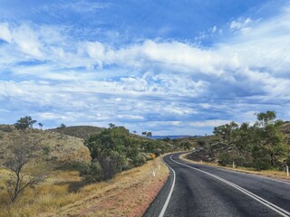 Beautiful shot of a road near the Ayers Rock during the day in Australia