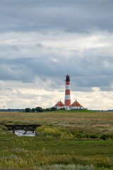 Fototapeta na wymiar Vertical shot of Westerheversand lighthouse in Schleswig-Holstein, Germany