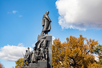 Taras Shevchenko Monument in Kharkiv city park. Autumn vibes, yellow trees and blue sky with white clouds in Shevchenko City Garden, Ukraine - obrazy, fototapety, plakaty