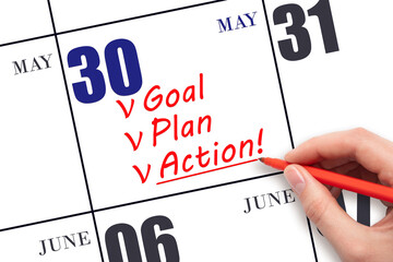 Hand writing text GOAL PLAN ACTION  on calendar date May 30. Motivation for a new day. Business...