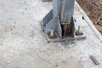 Metal structures on the construction of a house.Fastening of metal structures to the foundation.
