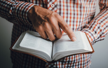 Man reading the bible pointing the text