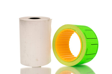 One roll of paper price tags and one roll of cash register tape, macro, isolated on white background.