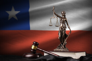 Chile flag with statue of lady justice, constitution and judge hammer on black drapery. Concept of...