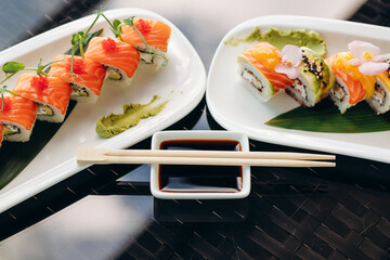 Japanese sushi cuisine. Rolls with salmon, shrimp, crab and avocado. Top view of a variety of sushi. Rainbow sushi roll.
