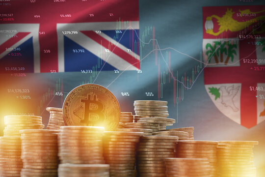 Fiji flag and big amount of golden bitcoin coins and trading platform chart. Crypto currency - Powered by Adobe