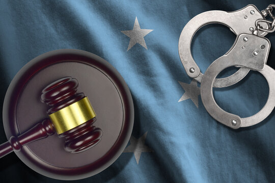 Micronesia flag with judge mallet and handcuffs in dark room. Concept of criminal and punishment, background for judgement topics