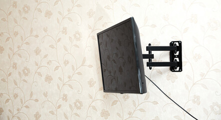 Swivel TV bracket LED display. Side view. X-shaped red fasteners. Black color. Multiplanar. Hangs...