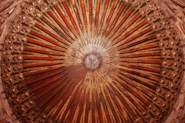 Low-angle closeup of a beautiful wooden ceiling in an old Moroccan style