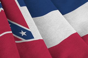Mississippi new US state flag with big folds waving close up under the studio light indoors. The...
