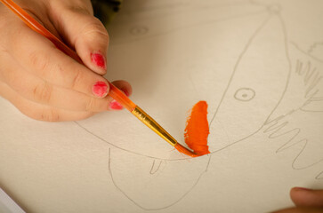 The child paints a picture. Education, inspiration, joy.
