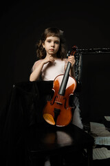 studio portrait of a young violinist with a violin
