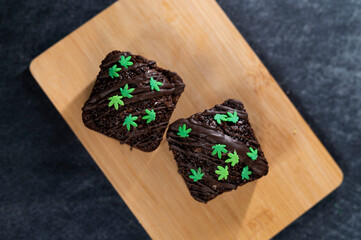 Chocolate cake with sprinkles on a wooden table
