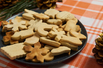 Close-up of a homemade freshly baked gingerbread cookies on the kitchen table. Merry Christmas and Happy New Year. Holidays. Festive bakery and culinary