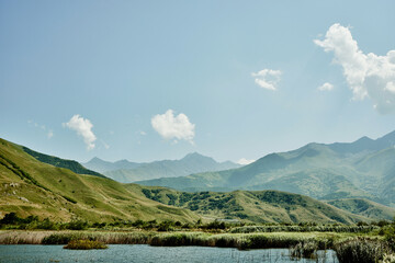 Mountain landscape with lake on sunny day. North Ossetia-Alania, Russia.
