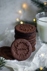 Norwegian Christmas spiced cookies pepperkaker with glass of milk on white background 