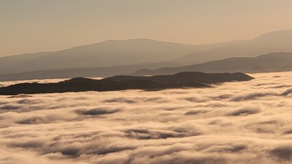 Fototapeta na wymiar mountaintops in the clouds