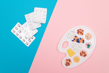 Global Pharmaceutical Industry and Medicinal Products - Different Colored Pills, Tablets and Capsules on White Art Palette with Pill Packages Lying on Split Blue and Pink Background, Flat Lay