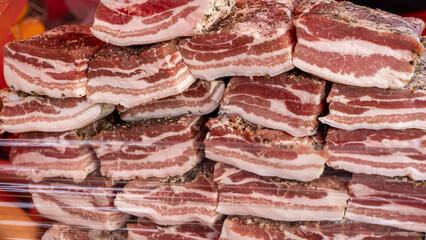 Large pieces of salted bacon. According to traditional Ukrainian recipes. Handmade trade in the rural market.