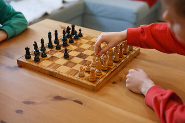 Fototapeta Two boys playing wooden chess obraz