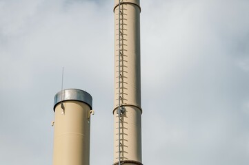 Boiler house chimney with stairs on a cloudy day