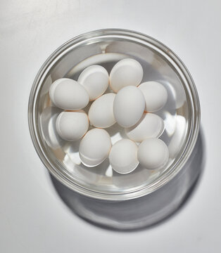 Eggs in water in glass bowl