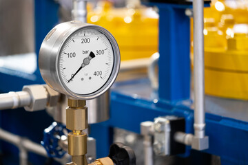 Industrial  concept. equipment of the boiler-house, - valves, tubes, pressure gauges, thermometer. Close up of manometer, pipe, flow meter, water pumps and valves of heating system in a boiler room.