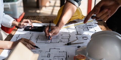 Architect team working with blueprints for architectural plan, engineer sketching a construction...