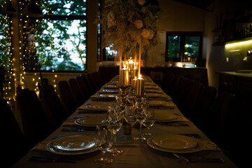 Luxury elegant table setting dinner with candles and light bulbs in a restaurant