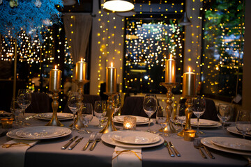 Luxury elegant table setting dinner with candles and light bulbs in a restaurant