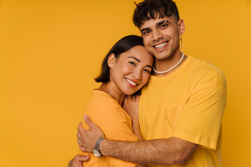 Young multiracial couple hugging while smiling together