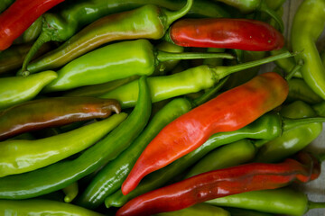 Hot chili pepper background. Red and green peppercorns as a background. Healthy food concept.