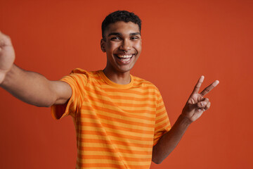 Selfportrait of young handsome smiling happy african man in t-shirt