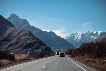 road in snowy mountains on a sunny day