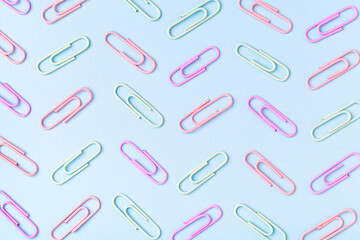 Multiple paperclip, flat lay group of objects on blue background