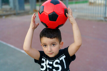 Portrait of little child with soccer ball.