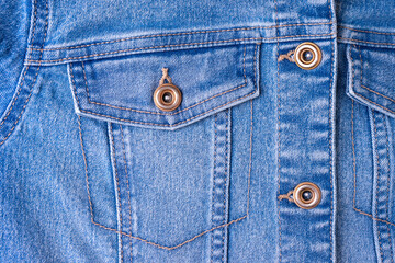 Denim jeans texture background with pocket. Texture of blue colored cotton fabric with decorative seam and buttons. Stitched texture jeans background. Fiber and fabric structure. Fashion, shopping