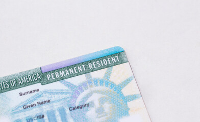United States passport, social security card and permanent  resident (green) card on white...