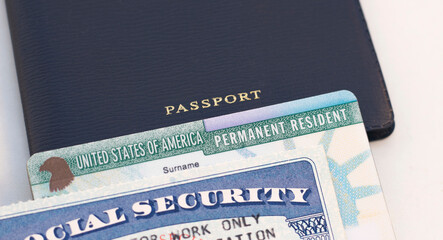 United States passport, social security card and permanent  resident (green) card on white...