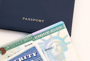 United States passport, social security card and permanent  resident (green) card on white...