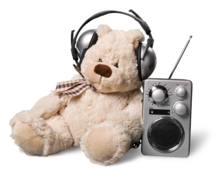 Teddy dear in headphones and radio isolated on white