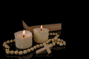 Image With Cross, Bible and Canndles,Rosary with crucifix lying on black