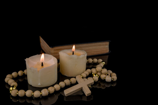 Image With Cross, Bible and Canndles,Rosary with crucifix lying on black