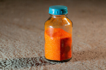 Orange poweder Ammonium dichromate in a glass bottle