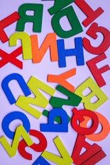 multi colored wooden letters on the white background