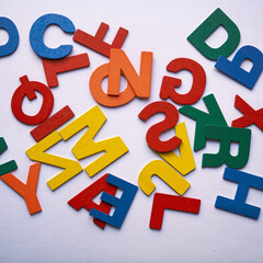 multi colored wooden letters on the white background