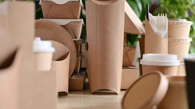 Moving the camera along various paper disposable tableware and food packaging.