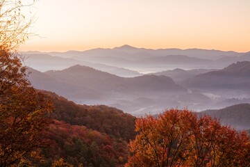 A beautiful sunrise near Great Smoky Mountains National Park. The trees are peak autumn colors and...